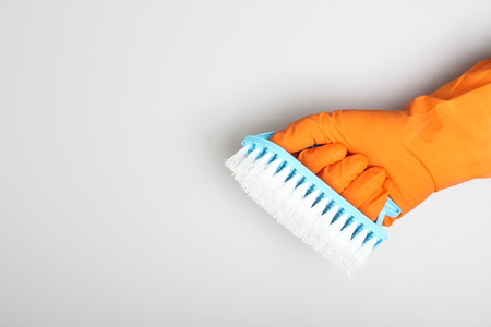 orange glove and blue brush