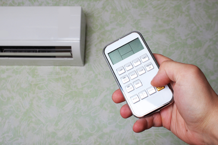 remote controller air conditioner in handの写真素材