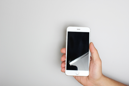 phone in hand on a light backgroundの写真素材