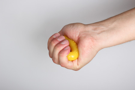 expander in hand on a light backgroundの写真素材