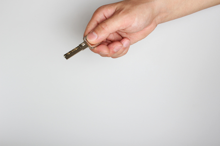 key in hand on a light backgroundの写真素材