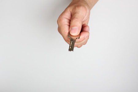 key in hand on a light backgroundの写真素材