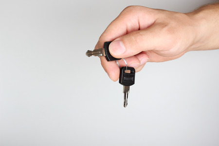 key in hand on a light backgroundの写真素材