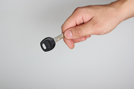 key in hand on a light backgroundの写真素材