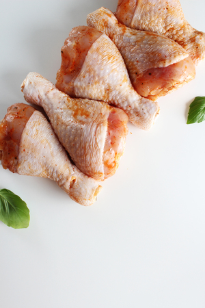 Chicken drumstick in marinade on a light backgroundの写真素材