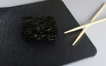 nori cabbage leaf on a dark stone backgroundの写真素材