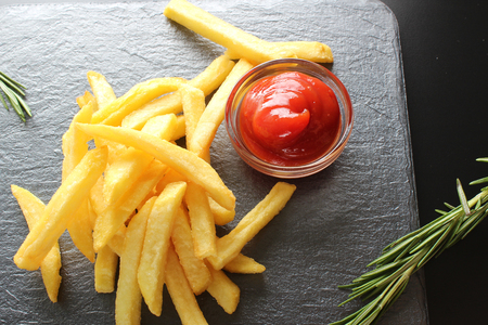 french fries and ketchup on a dark backgroundの写真素材