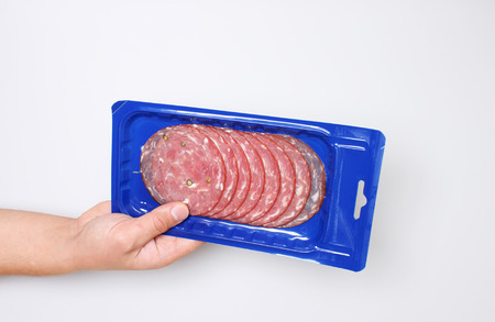 blue vacuum packing sausage cut hold hand