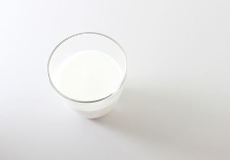 milk foam glass on a light backgroundの写真素材