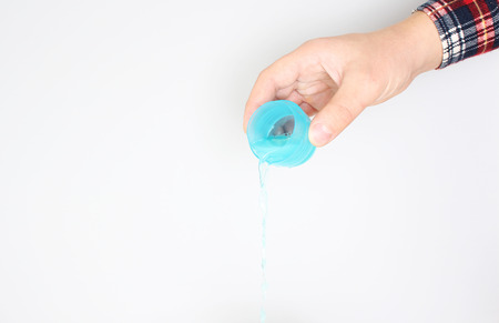 detergent measuring cup in hand
