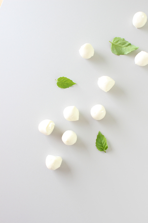 mozzarella cheese on a light gray basil backgroundの写真素材