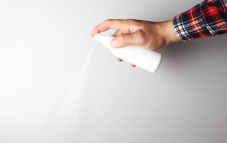 spray gun in hand on gray backgroundの写真素材