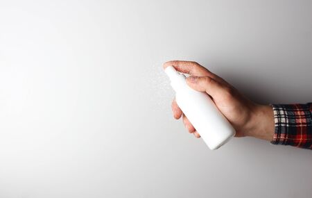 spray gun in hand on gray backgroundの写真素材