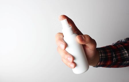 spray gun in hand on gray backgroundの写真素材