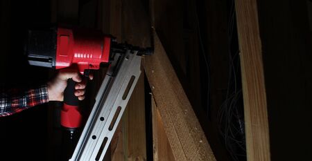 red pneumatic nails nailing hand gunの写真素材