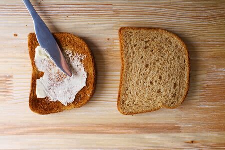 toast with butter on a wooden backgroundの写真素材