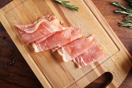 bacon sliced on a wooden backgroundの写真素材