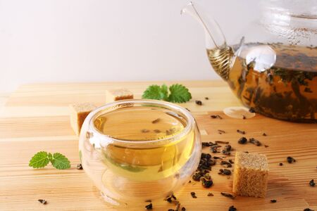 tea cup teapot sugar wooden backgroundの写真素材