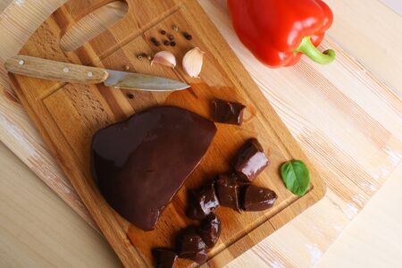 Beef liver on a wooden background, liver of beefの写真素材