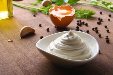 mayonnaise sour cream sauce on a wooden background cookingの写真素材