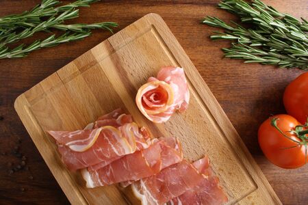 bacon sliced on a wooden backgroundの写真素材