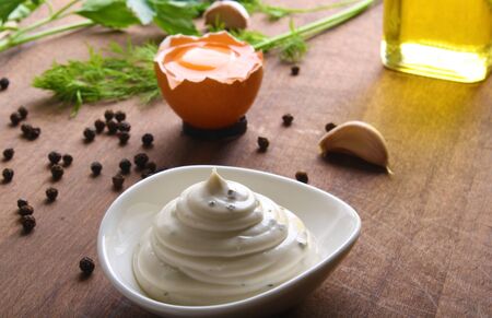 mayonnaise sour cream sauce on a wooden background cookingの写真素材
