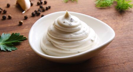 mayonnaise sour cream sauce on a wooden background cookingの写真素材