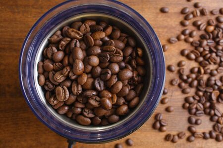 coffee beans in an electric coffee grinderの写真素材