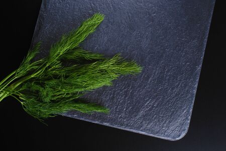 dill on a dark stone backgroundの写真素材
