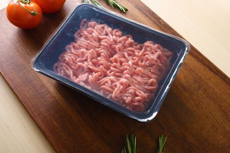 minced meat in packing on a wooden backgroundの写真素材