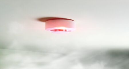 fire alarm sensor on a green light backgroundの写真素材