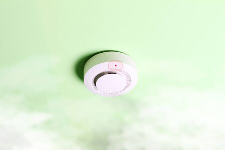 fire alarm sensor on a green light backgroundの写真素材