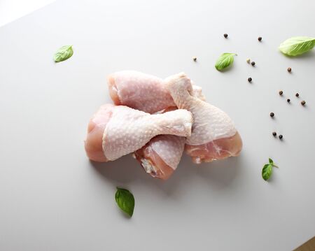 fresh chicken drumstick on a light backgroundの写真素材