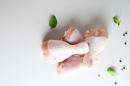 fresh chicken drumstick on a light backgroundの写真素材