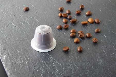 capsules of coffee on a stone backgroundの写真素材