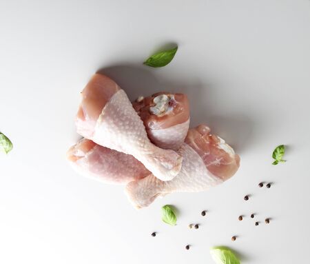 fresh chicken drumstick on a light backgroundの写真素材