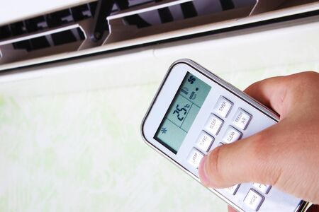 remote controller air conditioner in handの写真素材