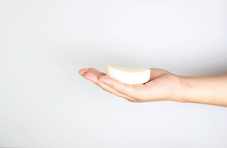 soap in a hand on a light backgroundの写真素材