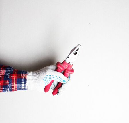 construction pliers red gloved handの写真素材