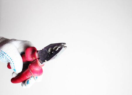construction pliers red gloved handの写真素材