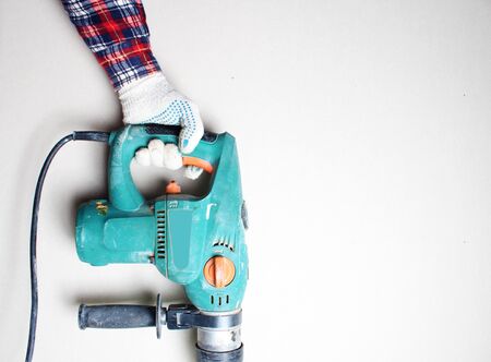 gloved hand drill hammer drill greenの写真素材