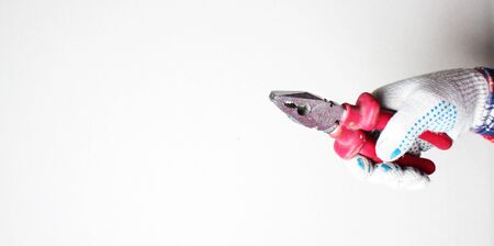 construction pliers red gloved handの写真素材