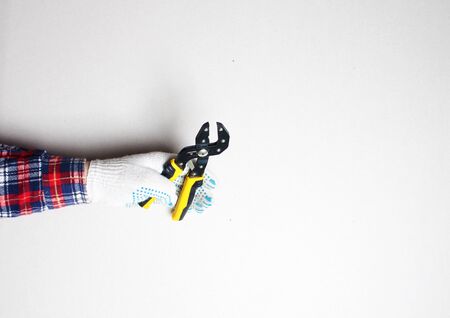 yellow building clamp in hand gloveの写真素材