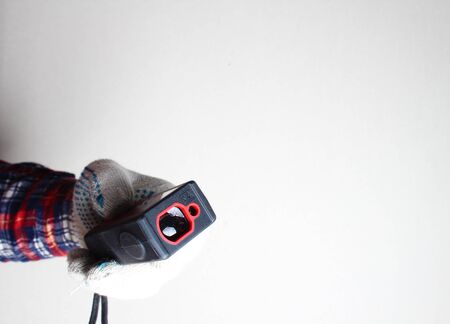 laser range finder builder hand in gloveの写真素材