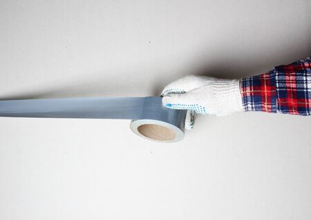 construction tape silver gloved handの写真素材
