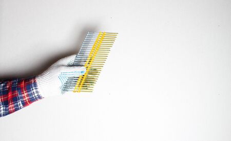 nails for construction gloved handの写真素材