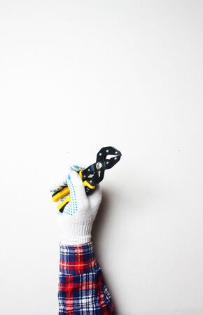 yellow building clamp in hand gloveの写真素材