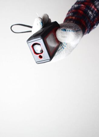laser range finder builder hand in gloveの写真素材
