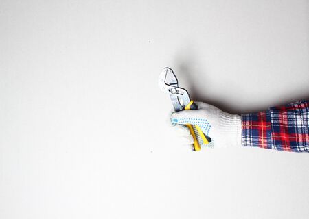 yellow building clamp in hand gloveの写真素材