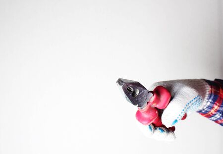 construction pliers red gloved handの写真素材